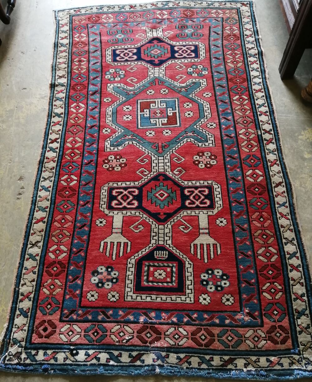 A Caucasian Kazak brick red ground rug, 178 x 102cm